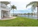 Inviting backyard with lush lawn, patio, and waterfront views creating a serene outdoor oasis at 442 Midway Is, Clearwater Beach, FL 33767