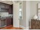 Close up on bar area with dark cabinets, granite countertop, and a wine cooler at 442 Midway Is, Clearwater Beach, FL 33767