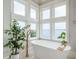 Bright bathroom with a freestanding tub and water views at 442 Midway Is, Clearwater Beach, FL 33767