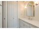 Bathroom featuring a sink with cabinets, closet, mirror, and overhead lighting at 442 Midway Is, Clearwater Beach, FL 33767