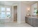 Spacious bathroom featuring a tub, vanity with light grey cabinetry and a water view at 442 Midway Is, Clearwater Beach, FL 33767