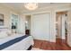 Bedroom showcasing a closet and entrance to bathroom with beautiful hardwood floors at 442 Midway Is, Clearwater Beach, FL 33767