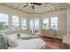 Bright bedroom boasting stunning water views with an elegant ceiling fan and wood floors at 442 Midway Is, Clearwater Beach, FL 33767