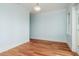 Light and airy room with hardwood floors, light blue walls, white trim, and a simple light fixture at 442 Midway Is, Clearwater Beach, FL 33767