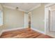 Bright, empty bedroom featuring light-beige walls, hardwood floors, and white trim at 442 Midway Is, Clearwater Beach, FL 33767