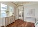 Light-filled bedroom featuring a stylish dresser, wood floors, and views of the water at 442 Midway Is, Clearwater Beach, FL 33767