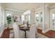 Formal dining room features seating for six and bright windows with a water view at 442 Midway Is, Clearwater Beach, FL 33767