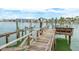 Private dock with a boat lift allowing seamless access to the waterway at 442 Midway Is, Clearwater Beach, FL 33767