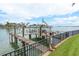 Waterfront dock featuring a boat lift providing convenient access to the open water at 442 Midway Is, Clearwater Beach, FL 33767