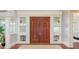 Elegant entryway featuring double wood doors with sidelights and wood flooring at 442 Midway Is, Clearwater Beach, FL 33767