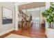 Grand foyer with staircase, wood floors, and high ceilings with water view windows at 442 Midway Is, Clearwater Beach, FL 33767