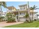 Charming two-story home with multi balconies, a two car garage, and beautiful palm trees at 442 Midway Is, Clearwater Beach, FL 33767