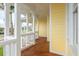 Exterior view of a yellow home featuring wood floors and white pillars along the outdoor patio at 442 Midway Is, Clearwater Beach, FL 33767