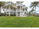 Exterior of the home with lush green lawn, multiple decks, and waterfront access at 442 Midway Is, Clearwater Beach, FL 33767