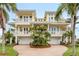 Beautiful home with two two-car garages, balconies, and circular brick drive at 442 Midway Is, Clearwater Beach, FL 33767