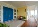 Inviting front porch featuring double doors, stylish seating, and elegant lighting fixtures at 442 Midway Is, Clearwater Beach, FL 33767