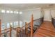 Hallway overlooking a lower level featuring iron decorative railing and wood floors at 442 Midway Is, Clearwater Beach, FL 33767