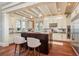 Gourmet kitchen with island, modern appliances, custom cabinetry, and stylish pendant lights at 442 Midway Is, Clearwater Beach, FL 33767