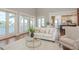 Living room with water views, large windows, white sofas, and light decor at 442 Midway Is, Clearwater Beach, FL 33767