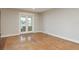 Spacious living room with neutral paint features glass doors leading to outdoor patio with water views at 442 Midway Is, Clearwater Beach, FL 33767