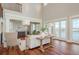 Bright living room with waterfront views, high ceilings, and stylish furnishings at 442 Midway Is, Clearwater Beach, FL 33767