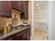 Walk-in pantry with custom shelving and ample storage at 442 Midway Is, Clearwater Beach, FL 33767
