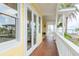 Inviting porch featuring wood floors, white railings, and scenic views of the water at 442 Midway Is, Clearwater Beach, FL 33767
