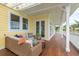 Inviting porch with wicker furniture, offers outdoor living with scenic waterfront views at 442 Midway Is, Clearwater Beach, FL 33767