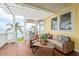 Inviting porch featuring wicker furniture, scenic water views, and wooden floors at 442 Midway Is, Clearwater Beach, FL 33767