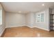 Empty room with neutral walls features two windows and shiny tile floors at 442 Midway Is, Clearwater Beach, FL 33767
