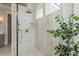 Shower with stone-look tile and brass fixtures at 442 Midway Is, Clearwater Beach, FL 33767