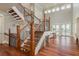Elegant staircase with wrought iron railings and wood treads leads to a sunlit living space at 442 Midway Is, Clearwater Beach, FL 33767