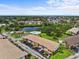 Scenic aerial view of the apartment complex with a pool, lake, lush greenery, and the city skyline at 4540 Overlook Ne Dr # 246, St Petersburg, FL 33703
