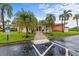 Inviting clubhouse entrance with well-manicured landscaping, palm trees and accessible parking at 4540 Overlook Ne Dr # 246, St Petersburg, FL 33703