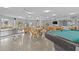 Well-lit common room offering table tennis, billiard table, seating areas and expansive windows at 4540 Overlook Ne Dr # 246, St Petersburg, FL 33703