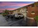 Condo building with brick accents and updated exterior, offering covered parking and well-maintained grounds at dusk at 4540 Overlook Ne Dr # 246, St Petersburg, FL 33703
