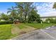 Community picnic area featuring a red park bench nestled among mature trees and lush landscaping at 4540 Overlook Ne Dr # 246, St Petersburg, FL 33703