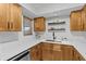 Bright kitchen with white countertops, wood cabinetry, and stainless steel dishwasher at 4540 Overlook Ne Dr # 246, St Petersburg, FL 33703