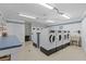 Clean community laundry room equipped with multiple washing machines, dryers, and utility sink at 4540 Overlook Ne Dr # 246, St Petersburg, FL 33703