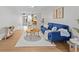Bright condo living room features comfortable seating, modern decor, natural light, and an adjacent kitchenette at 4540 Overlook Ne Dr # 246, St Petersburg, FL 33703