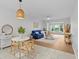 Inviting living space featuring modern decor, a blue sofa, stylish lighting, and a view of the outdoors at 4540 Overlook Ne Dr # 246, St Petersburg, FL 33703