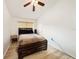 Cozy bedroom with a ceiling fan and wood laminate flooring, providing a comfortable retreat at 4668 66Th N Pl, Pinellas Park, FL 33781