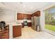 Bright kitchen with stainless steel appliances, wooden cabinetry and a backyard view at 4668 66Th N Pl, Pinellas Park, FL 33781