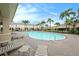 Resort-style pool surrounded by palm trees and comfortable lounge chairs, offering a luxurious experience at 4668 66Th N Pl, Pinellas Park, FL 33781