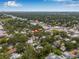 Aerial view showcases property's location in a lush neighborhood with easy access to commercial area and cityscape at 5101 N Suwanee Ave, Tampa, FL 33603