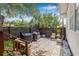 Private backyard brick patio with barbecue area, seating, and mature trees at 5101 N Suwanee Ave, Tampa, FL 33603