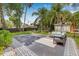 Beautiful backyard features a modern patio with lounge seating and well-maintained landscaping at 5101 N Suwanee Ave, Tampa, FL 33603