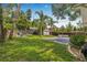Large backyard blending patio, firepit area, and green lawn, perfect for relaxing and entertaining in style at 5101 N Suwanee Ave, Tampa, FL 33603