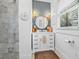 Stylish bathroom featuring a marble-topped vanity, sconce lighting, and a modern design at 5101 N Suwanee Ave, Tampa, FL 33603