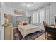 Cozy bedroom featuring a comfortable bed, natural light, and a workspace at 5101 N Suwanee Ave, Tampa, FL 33603